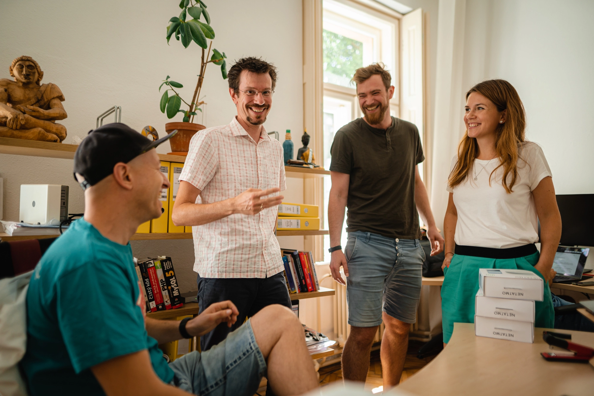 FatChilli employees talking together in an office.